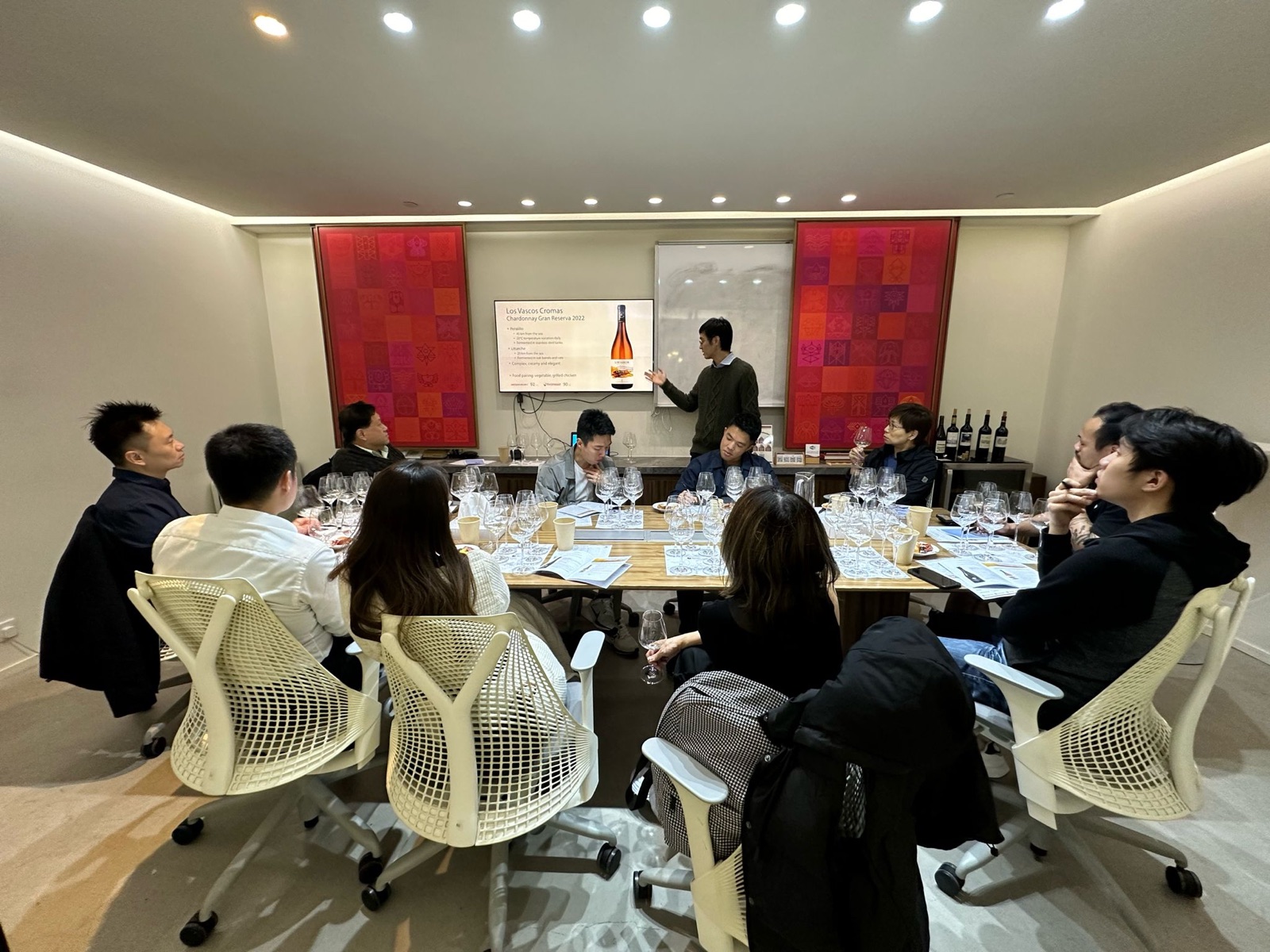 Guests around a tasting table during a wine presentation